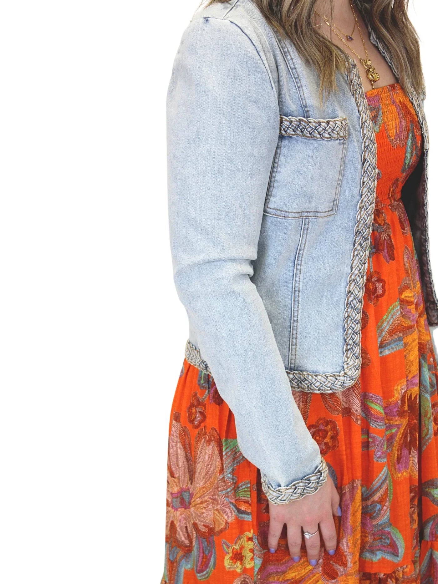 Light wash braided trim jean jacket on model, closeup side.