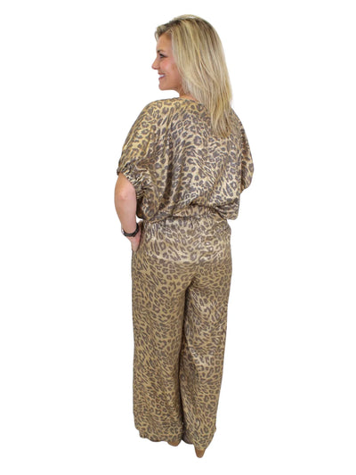 Model wearing tucked metallic leopard print top on white background, back.