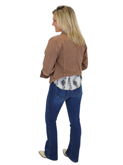 Model wearing washed brown denim jacket and jeans on white background, back.