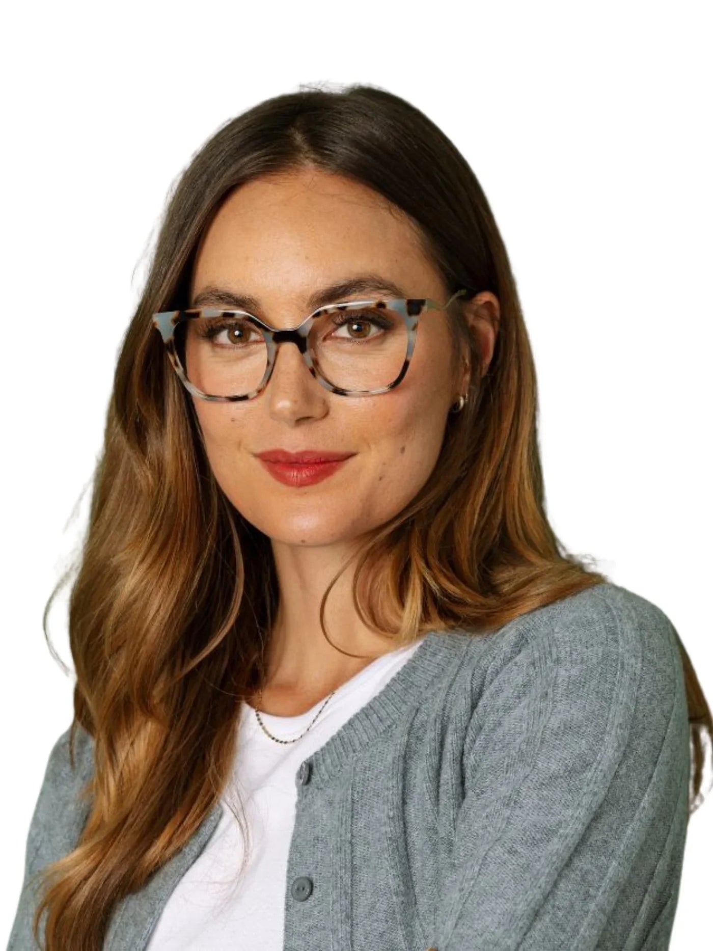 Woman wearing tortoiseshell rounded square glasses and a gray cardigan on a white background.