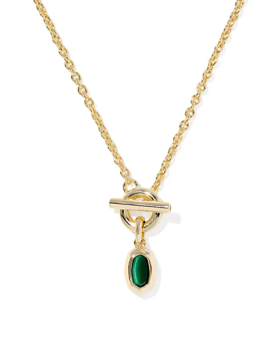 Gold necklace with a green gemstone pendant on a white background