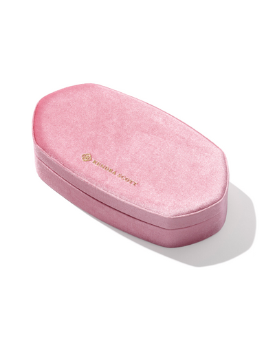 Pink velvet jewelry box with a brand logo on a white background