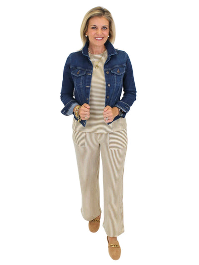 Model wearing brown and white striped knit set with jean jacket on white background, front.