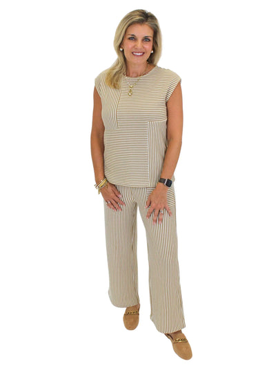 Model wearing brown and white striped knit set on white background, front.