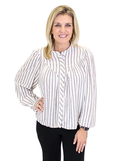 Woman wearing a striped shirt and black pants on a white background, closeup front.