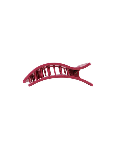 Maroon hair clip on white background, side.