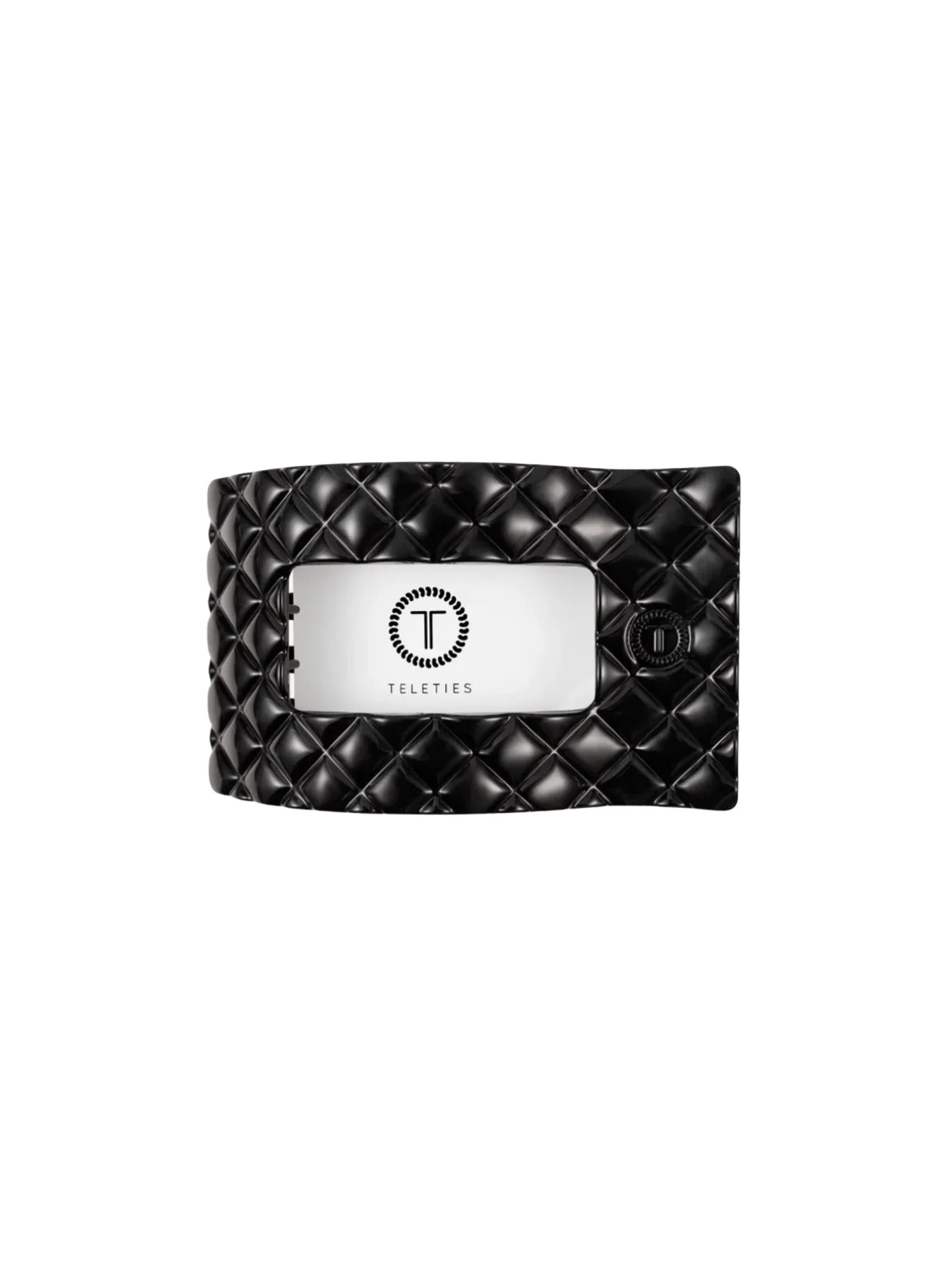 Black quilted rectangle hair clip on white background, front.