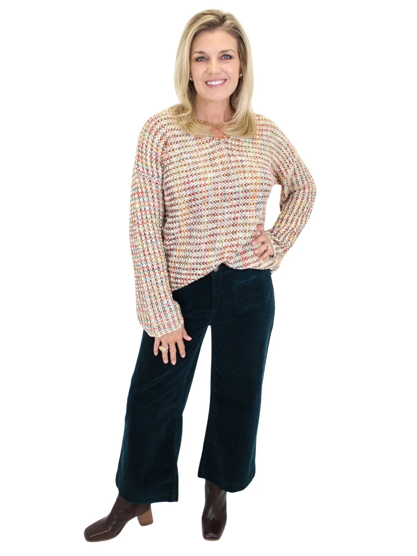 Woman wearing a multicolored crochet sweater on a white background, front