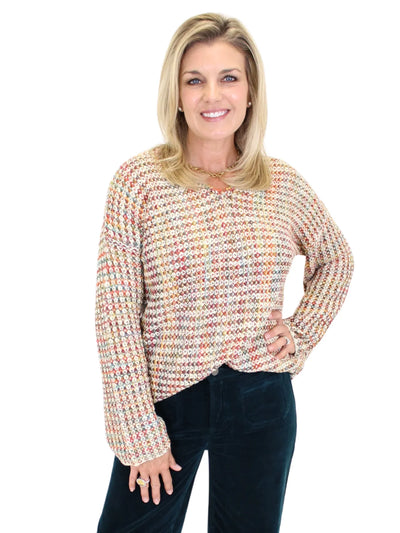 Woman wearing a multicolored crochet sweater on a white background, closeup