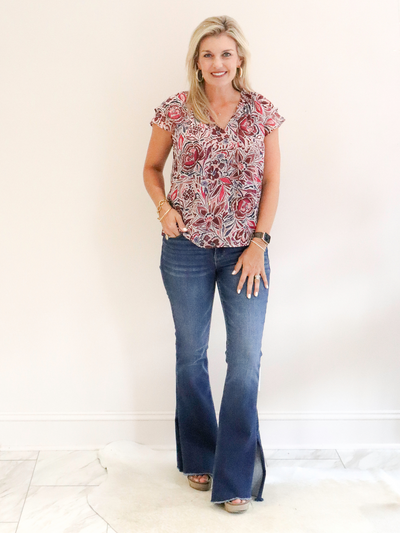 Orchid Floral Ruffle Top paired with jeans.