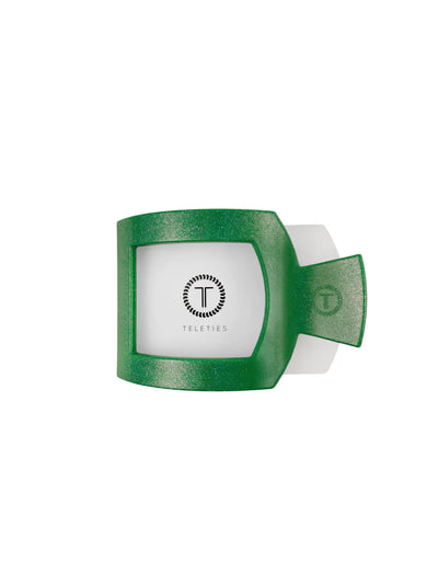 Sparkly green claw clip in packaging on white background, front.