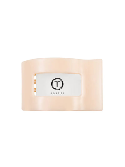 Packaged beige medium flat rectangle hair clip on white background, front.