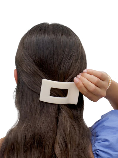beige small flat rectangle hair clip in model's hair.