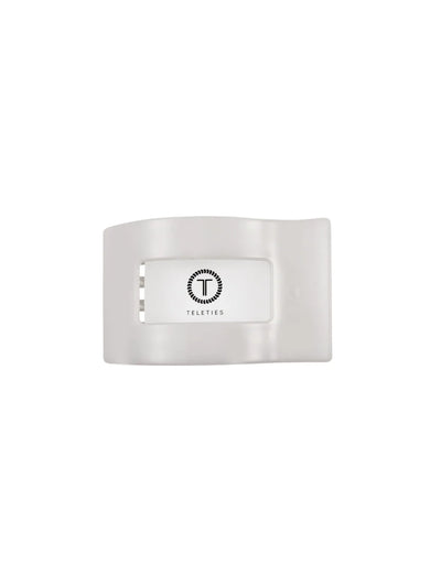 Packaged white small rectangular hair clip on white background, front.