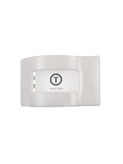 Packaged white medium rectangle hair clip on white background, front.