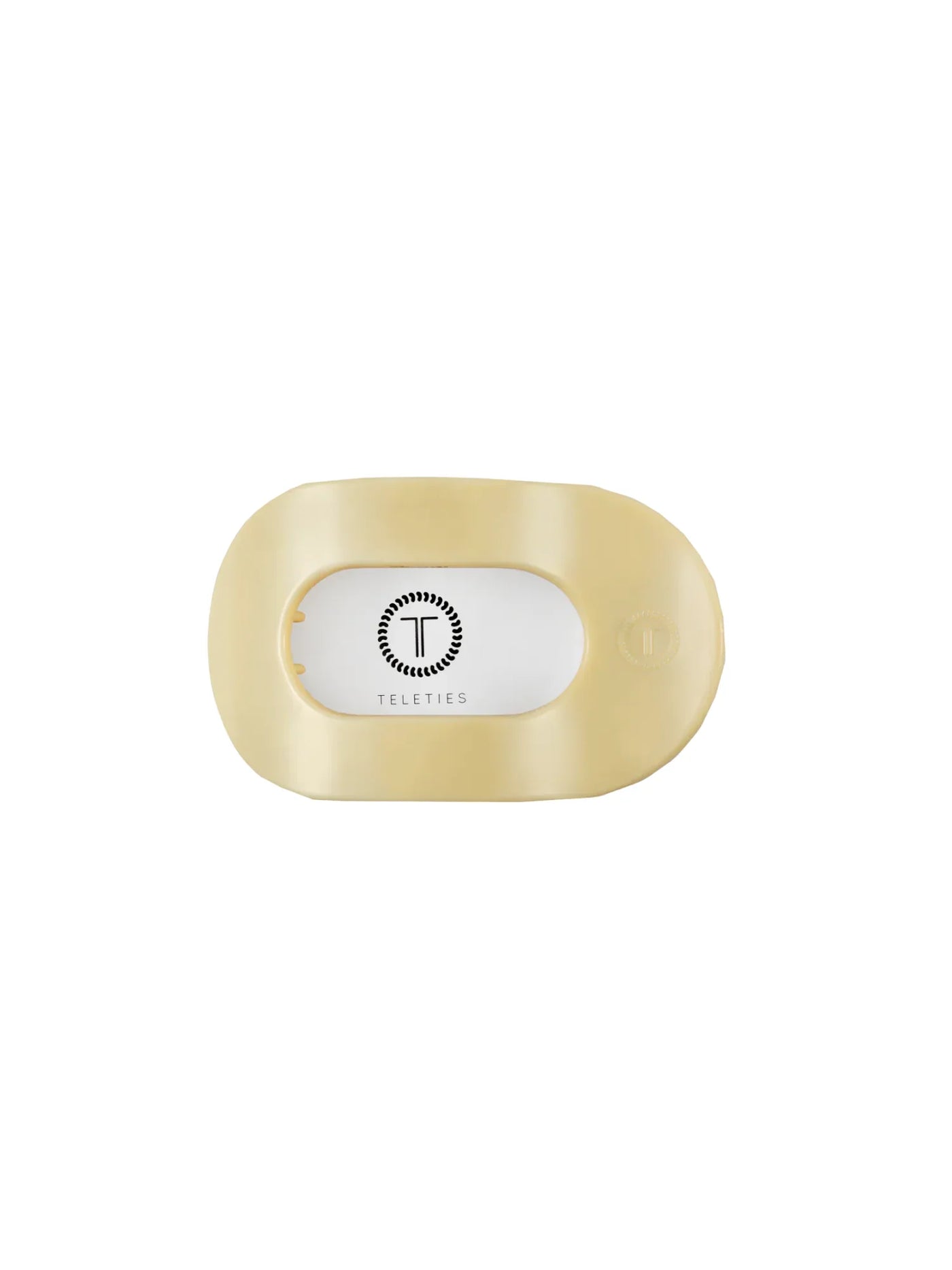 Packaged small yellow round hair clip on white background, front.