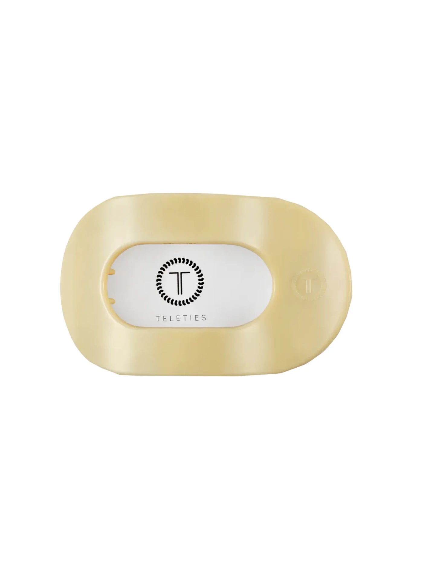 Packaged yellow large round hair clip on white background, front.