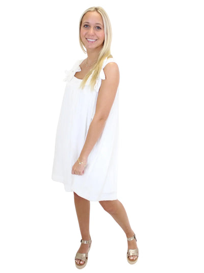 White dress with flower straps on model, front in motion.