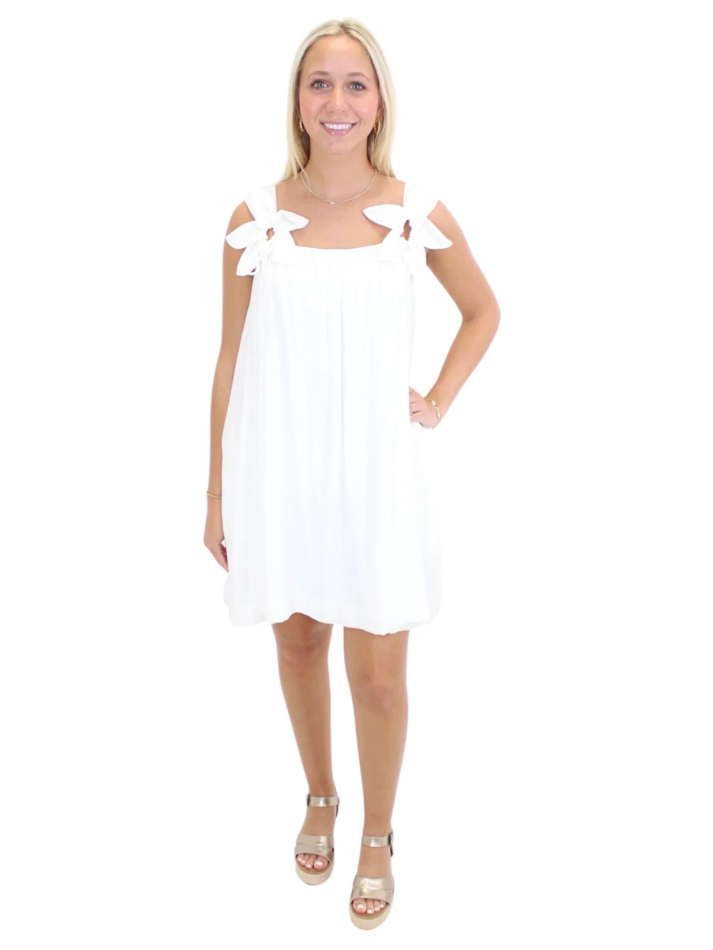 White dress with flower straps on model, front.