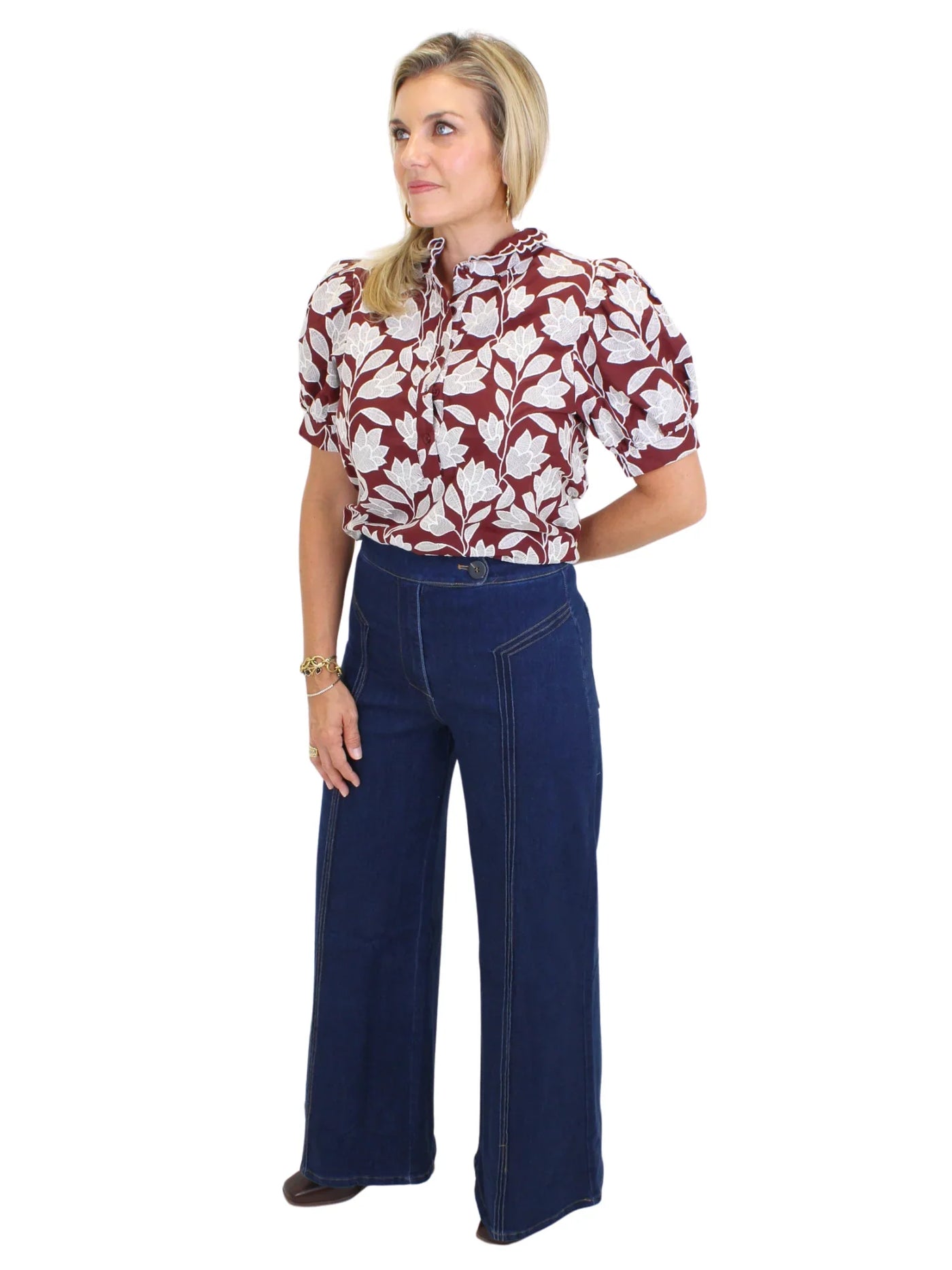 Model wearing dark wash wide leg jeans with front seam design on white background, front.