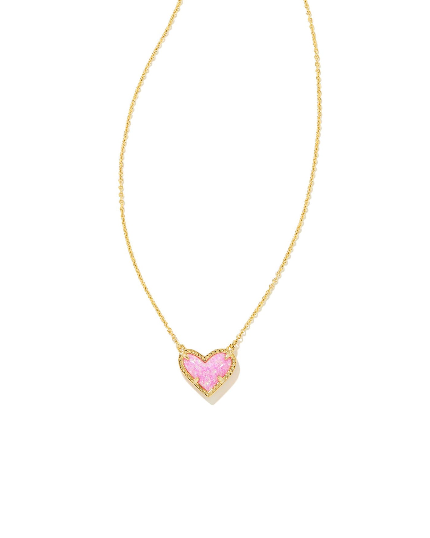 Kendra Scott Ari Heart Pendant Necklace in Gold Pink Kyocera Opal closeup.
