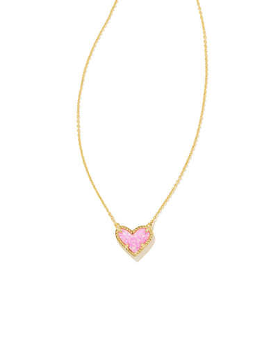 Kendra Scott Ari Heart Pendant Necklace in Gold Pink Kyocera Opal closeup.
