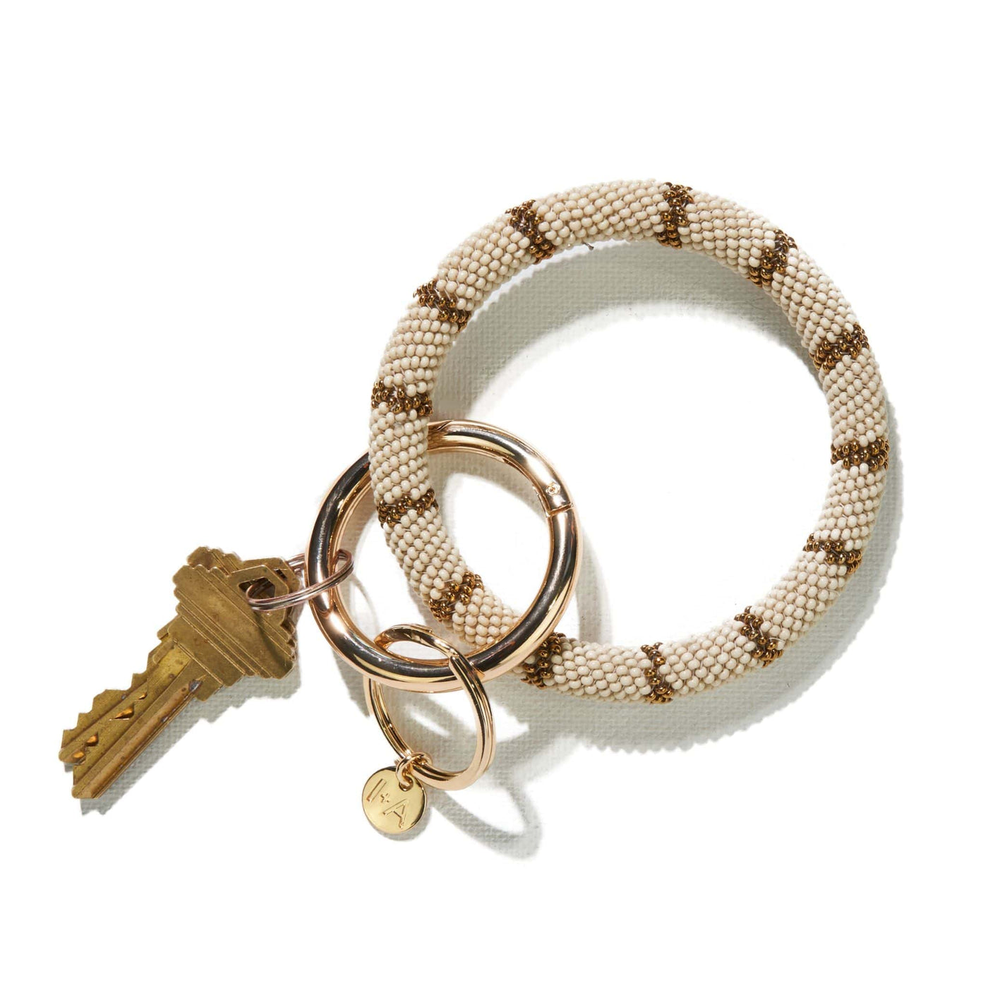 Chloe Key Ring in cream and gold, front view.