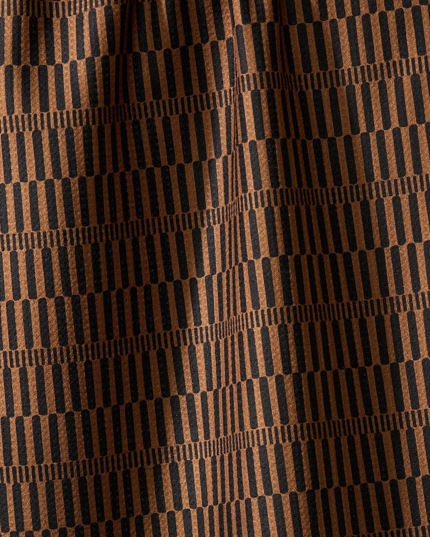 Closeup of brown and black striped tea towel.