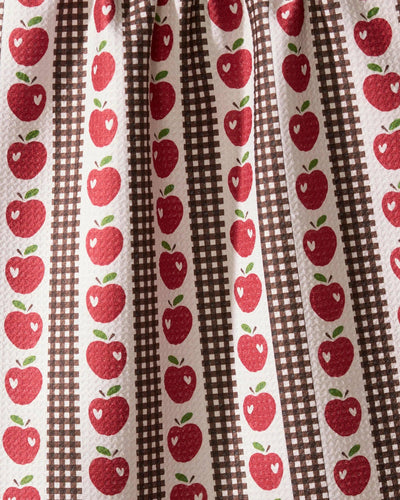 Fabric with red apple pattern on brown and white striped background