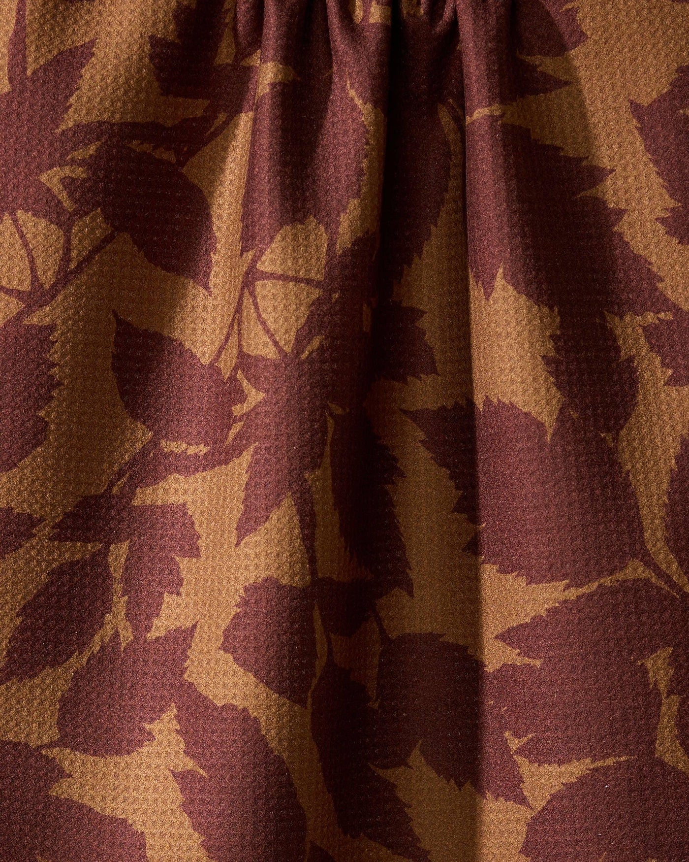 Closeup of brown tea towel with leaf print