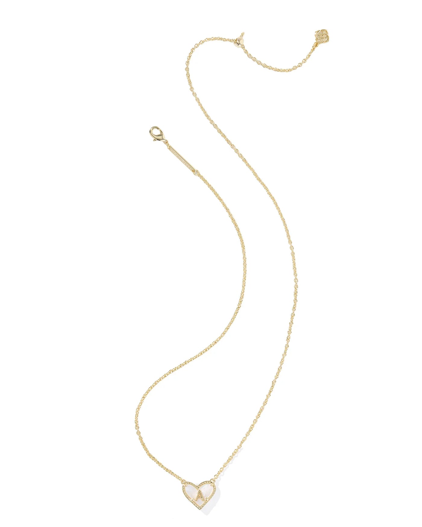Gold necklace with a heart-shaped pendant and letter "A" on a white background.