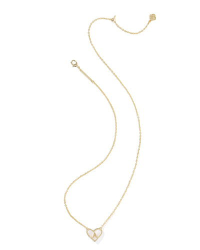 Gold necklace with a heart-shaped pendant and letter "A" on a white background.