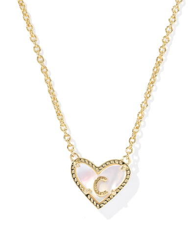 Gold necklace with a heart-shaped pendant and letter "C" on a white background.