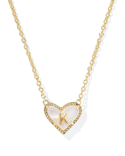 Gold necklace with a heart-shaped pendant and letter "K"on a white background.