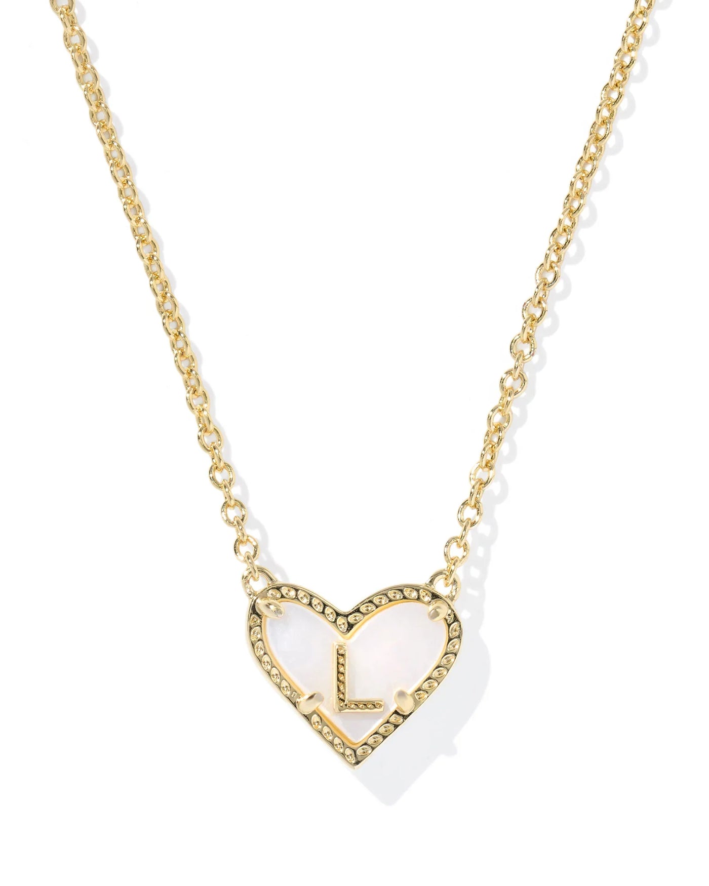Gold necklace with heart-shaped pendant and letter "L" on white background.