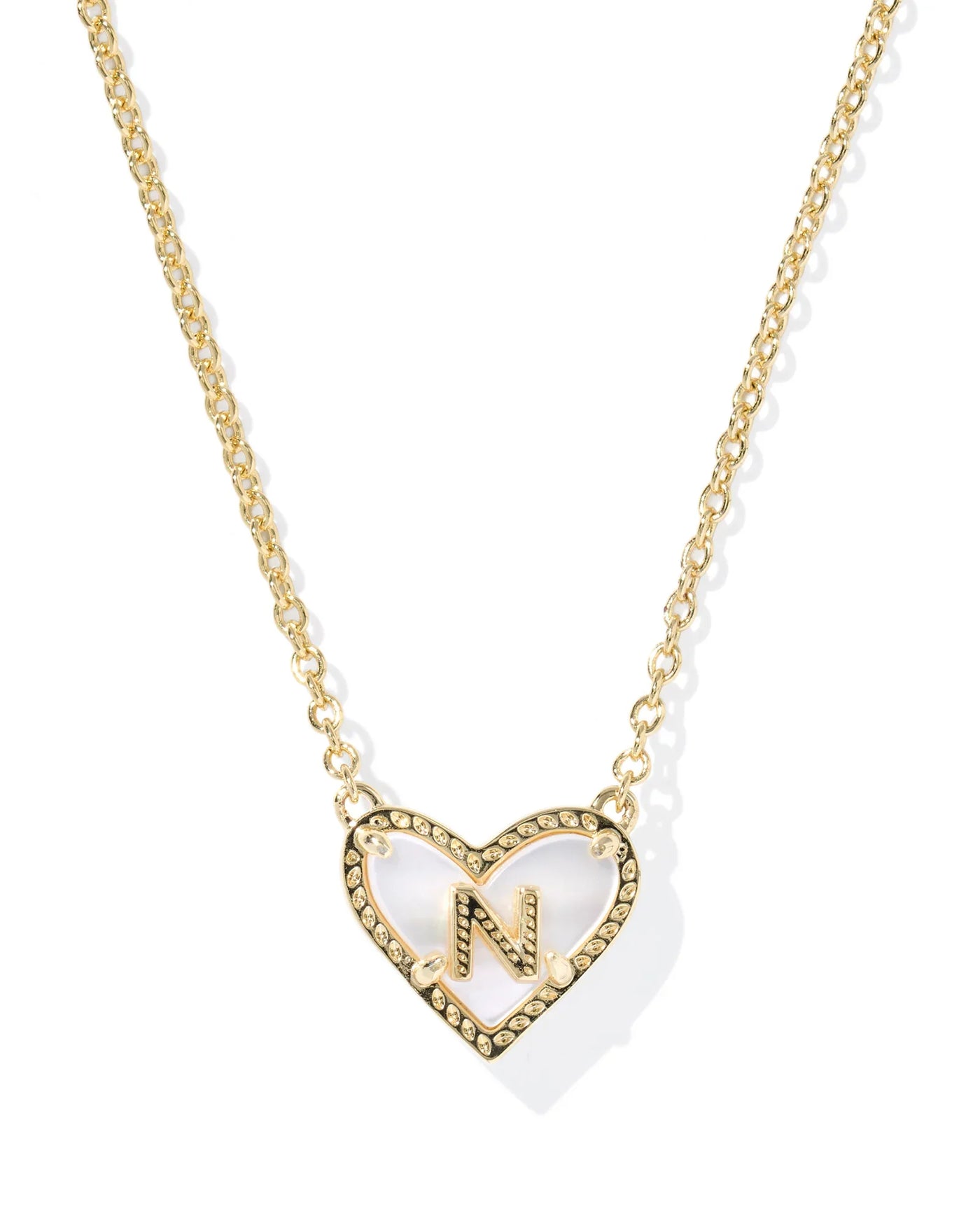 Gold necklace with heart-shaped pendant and letter "N" on white background.
