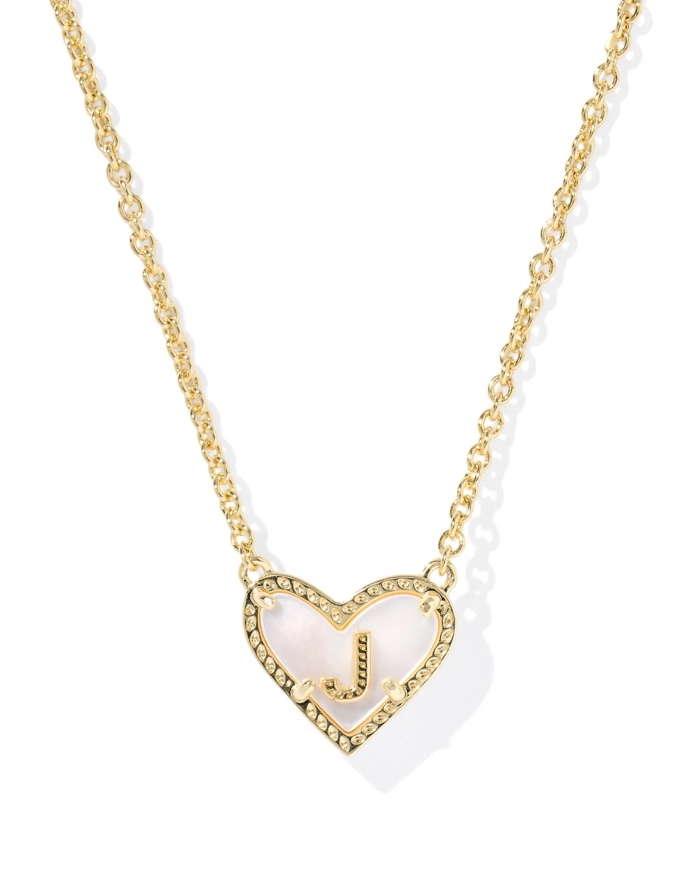 Gold necklace with a heart-shaped pendant and letter "J" on a white background.