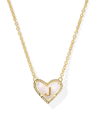 Gold necklace with a heart-shaped pendant and letter "J" on a white background.