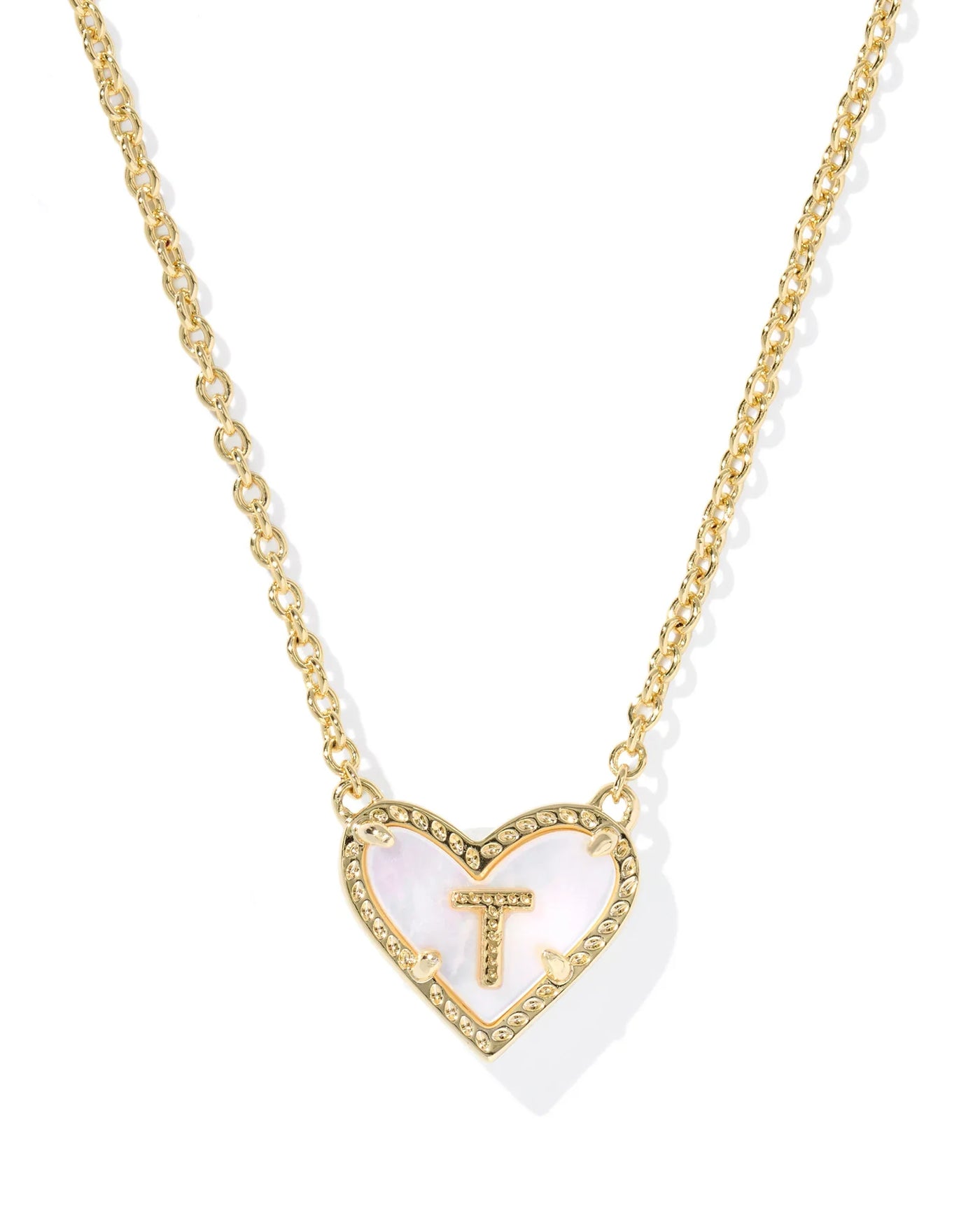 Gold necklace with a heart-shaped pendant featuring the letter 'T' on a white background.