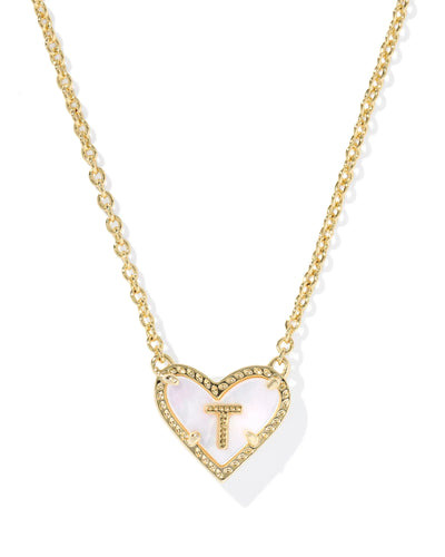 Gold necklace with a heart-shaped pendant featuring the letter 'T' on a white background.