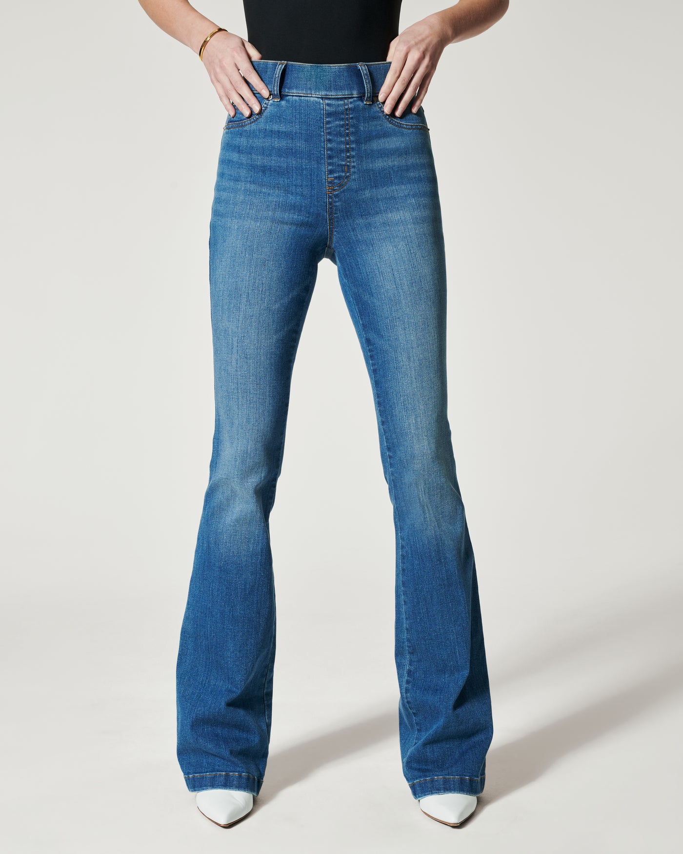 Spanx Flare Jeans in vintage indigo on model front view.