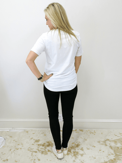 Back of tee is solid white with black jeans.