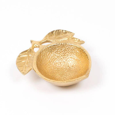 Gold painted metal trinket dish in the shape of a lemon with leaves on it