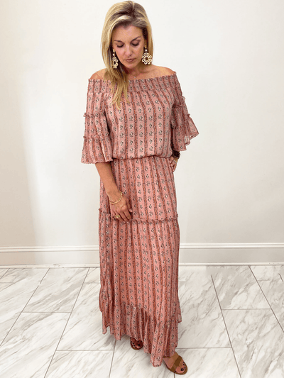 Pink abstract stripe tiered maxi skirt paired with the matching off shoulder top
