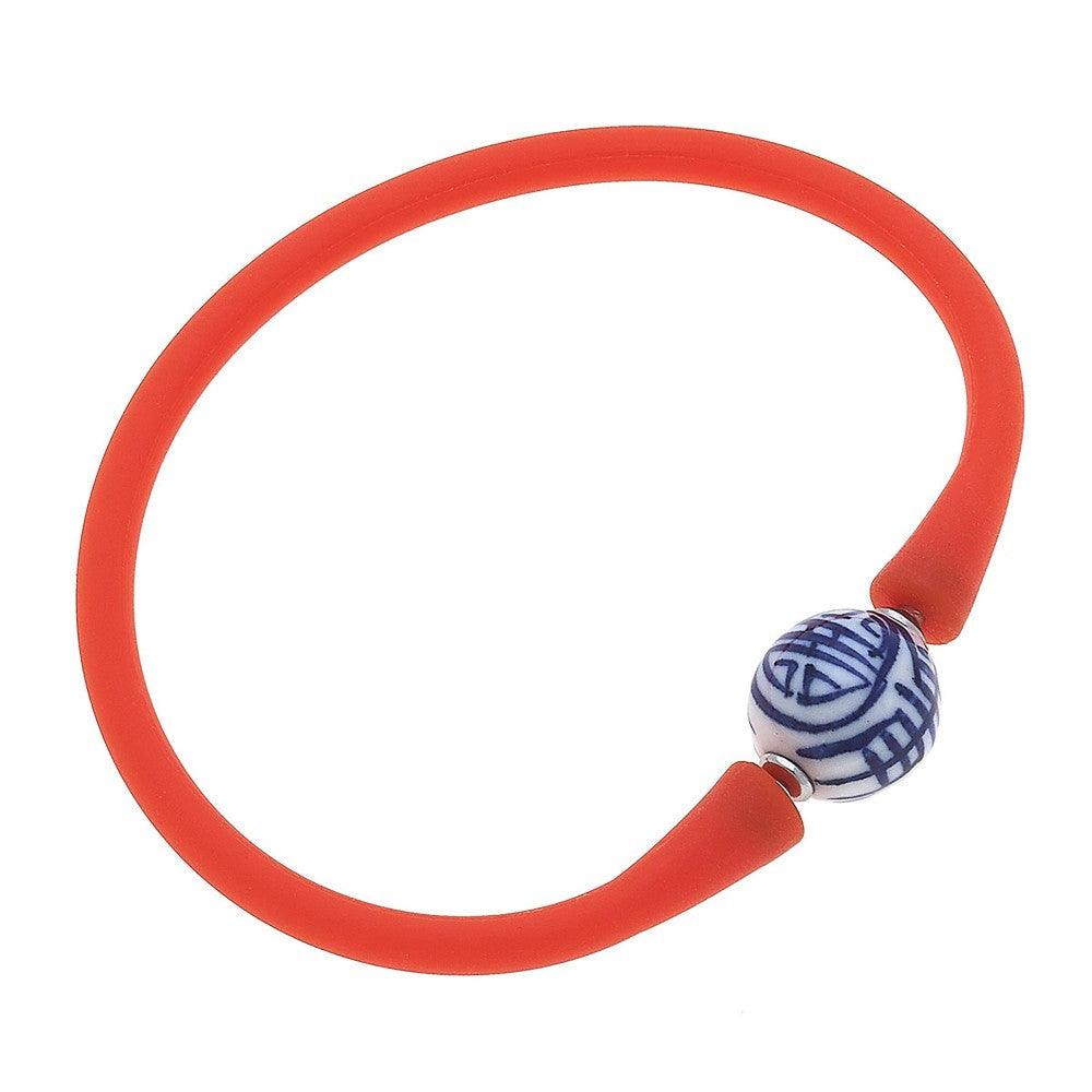 Red silicone bracelet with a small chinoiserie bead