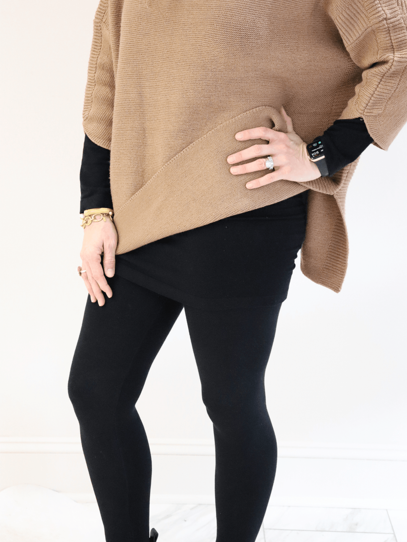 Long Sleeve Layering Top black under a tan Kerisma sweater. front view.