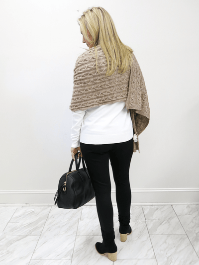 Full back view of taupe Kerisma sweater wrap with white Charlie Paige top, black Charlie Paige pants, black Charlie Paige slouch boots and black Katie Loxton handbag..