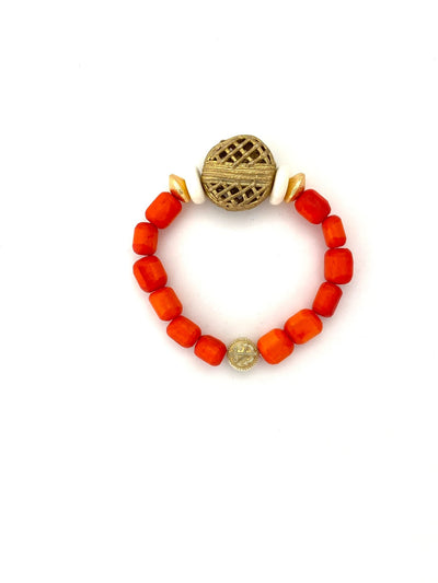 Full view of stretch bracelet with orange short tube beads, flat gold beads, flat white beads and a large textured gold beads
