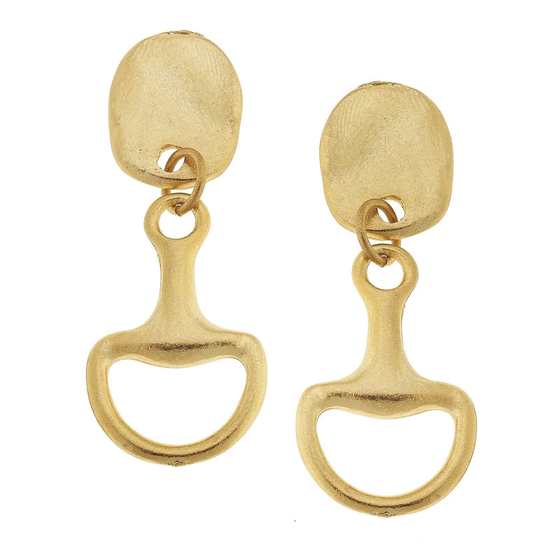 Up close view of gold, horse bit shaped dangle earrings