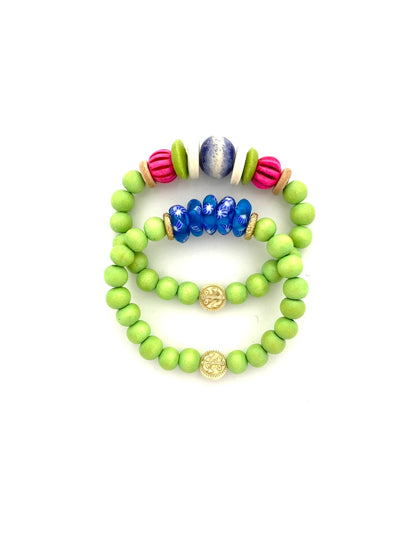 full view of round green, flat gold, round textured hot pink, flat white, and round blue bead stretch bracelet